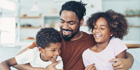 Happy father smiling with his children.