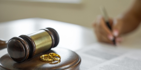 Woman signing divorce papers