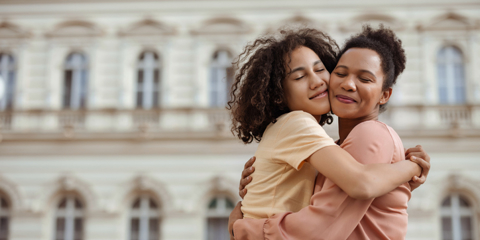 mother hugging teenage daughter