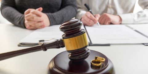 Hands of wife, husband signing decree of divorce