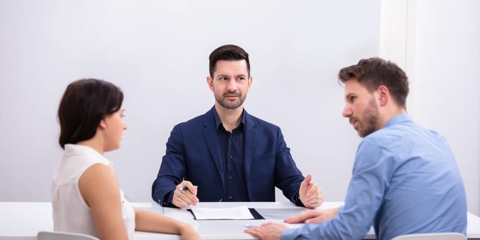 Rear View Of A Couple Sitting In Front Of Judge