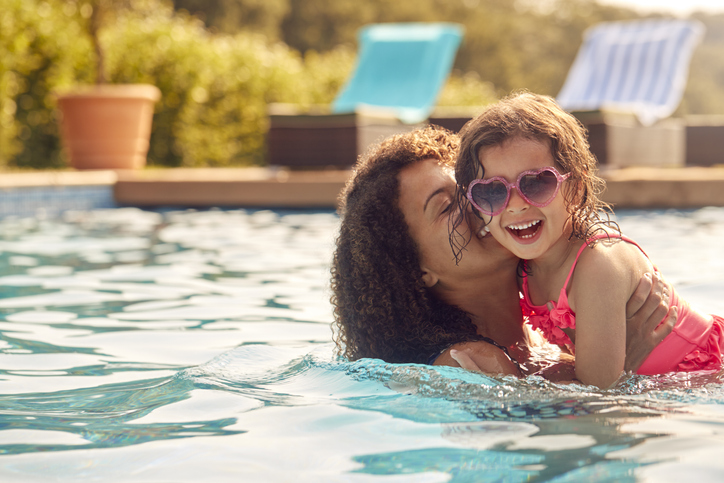 mother and daughter playing in the pool
