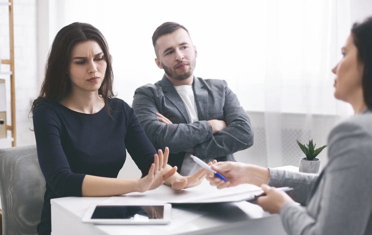 woman refusing to sign papers in a professional's office