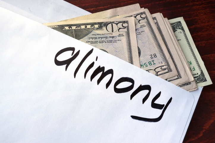 alimony written on an envelope holding money